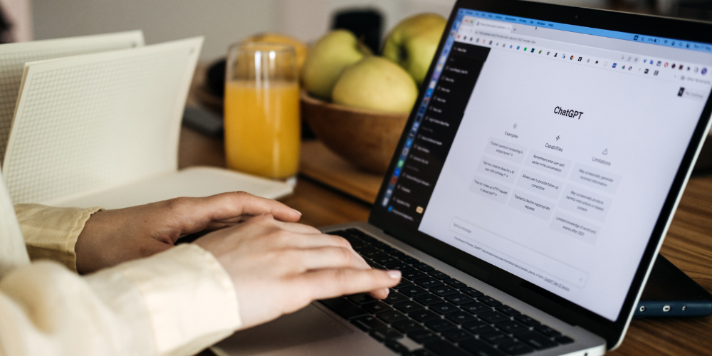 Person typing on ChatGPT on laptop - Dig & Dig