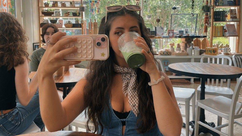 Gen Z influencer drinking a matcha latte and taking a photo in the mirror - Dig & Dig