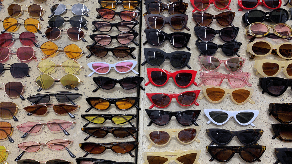 Rows of sunglasses on a table - Dig & Dig