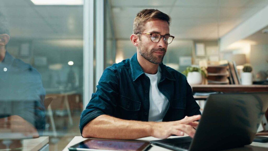 Man checking his laptop after SEO ranking has dropped - Dig & Dig