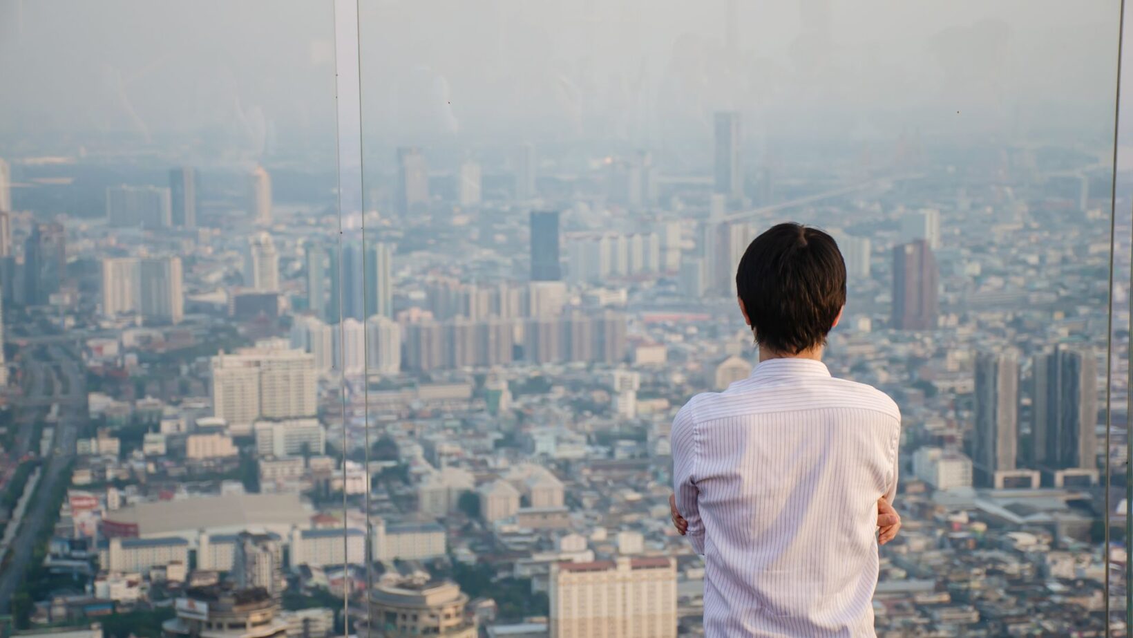 Man looking out window stressed because his SEO ranking has dropped - Dig & Dig