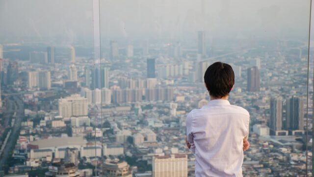 Man looking out window stressed because his SEO ranking has dropped - Dig & Dig