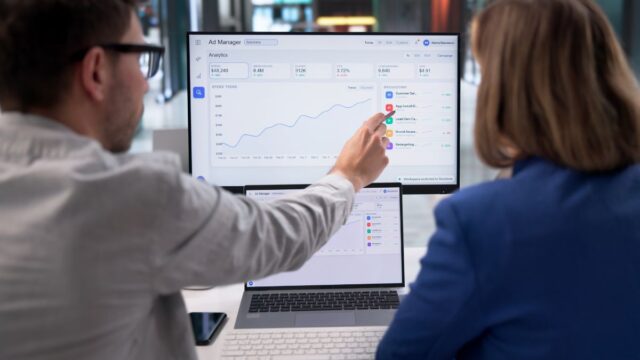 Two agency workers analysing paid social and programmatic B2B media strategy - Dig & Dig