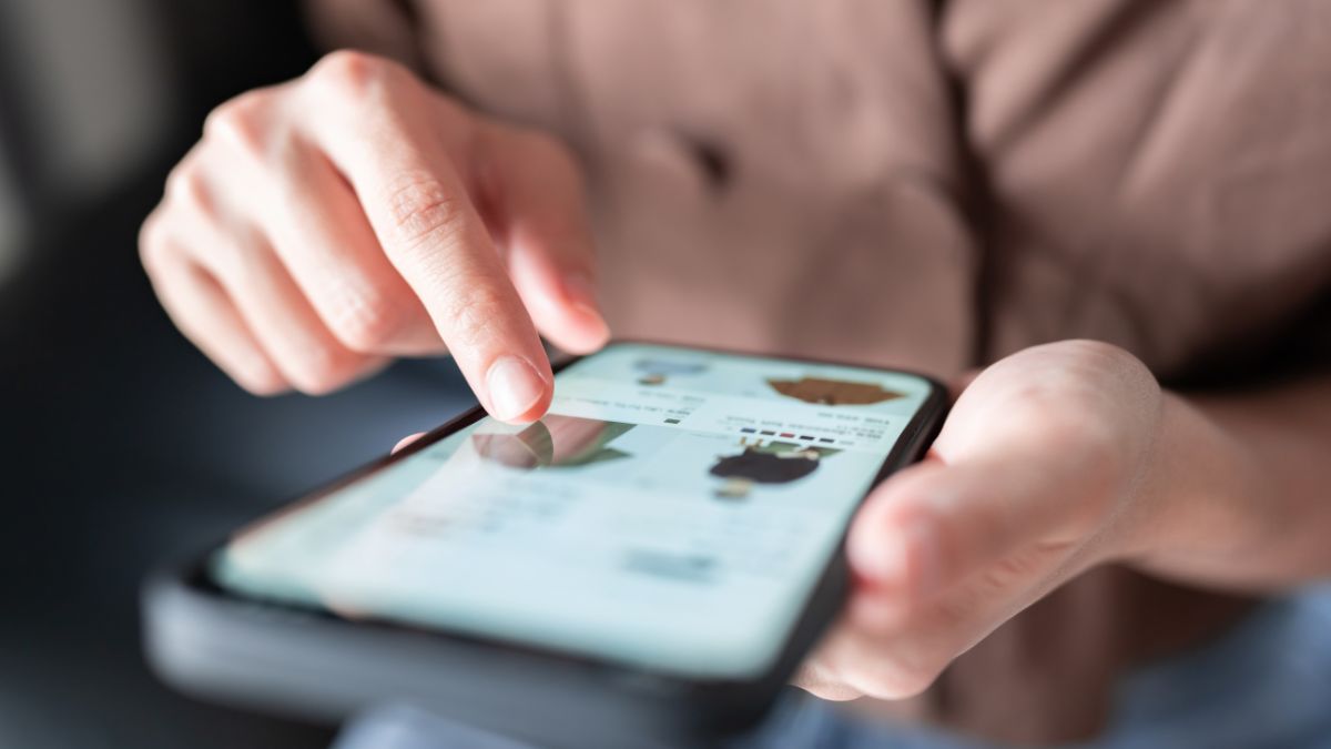 Person scrolling ecommerce site on phone following brand's successful black friday AI shopping optimization strategy - Dig & Dig