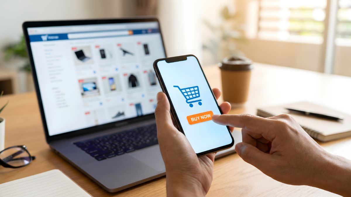Person holding phone to make purchase while looking on a laptop at ecommerce site on black friday AI search optimization - Dig & Dig