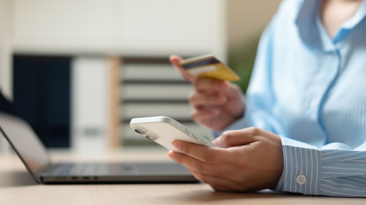Person on phone with credit making purchase after brand's black Friday AI search optimization strategy was successful - Dig & Dig